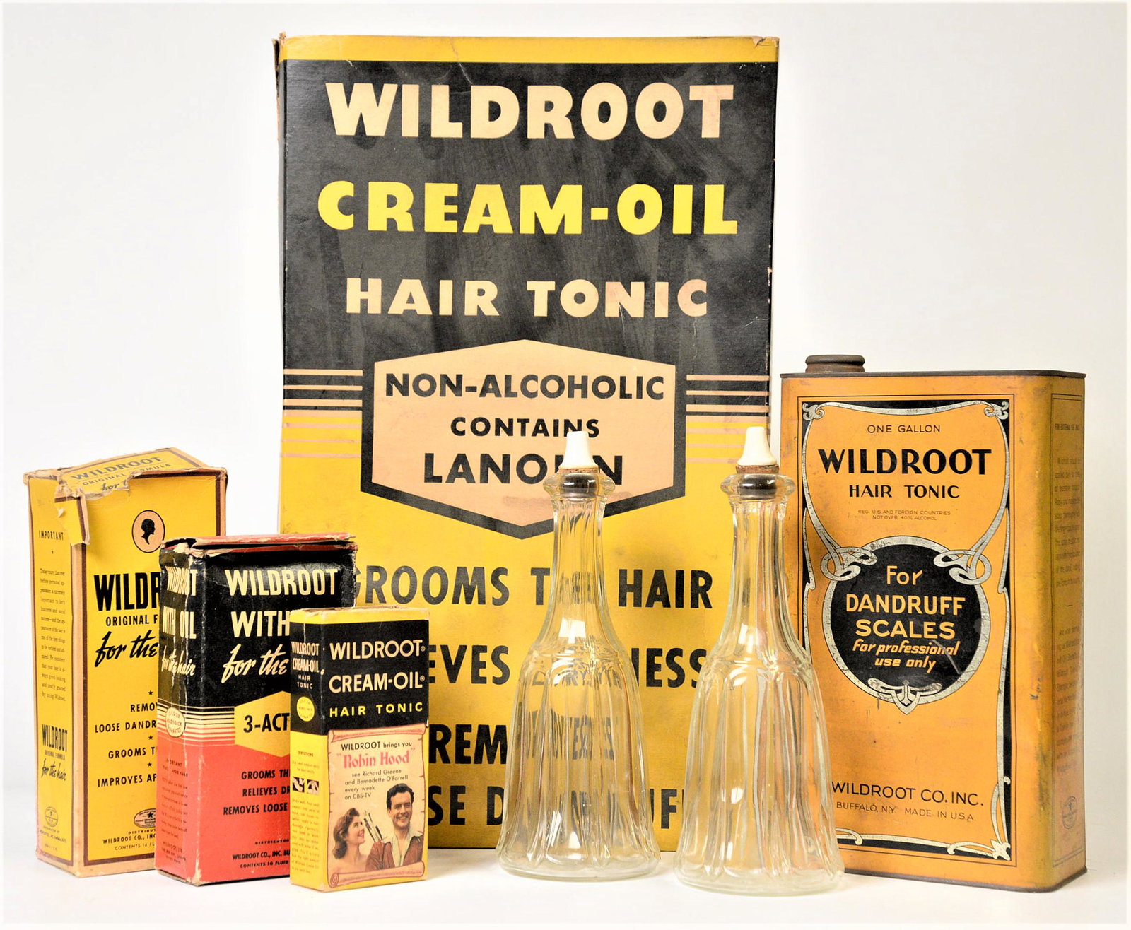Wildroot Products & Display: Lot of seven including an over-sized chromolithographed card stock display box of Wildroot Hair Tonic, 1 12 x 6 ½ x 19 ¼” high; plus chromolithographed tin can of Wildrot Hair Tonic, 6