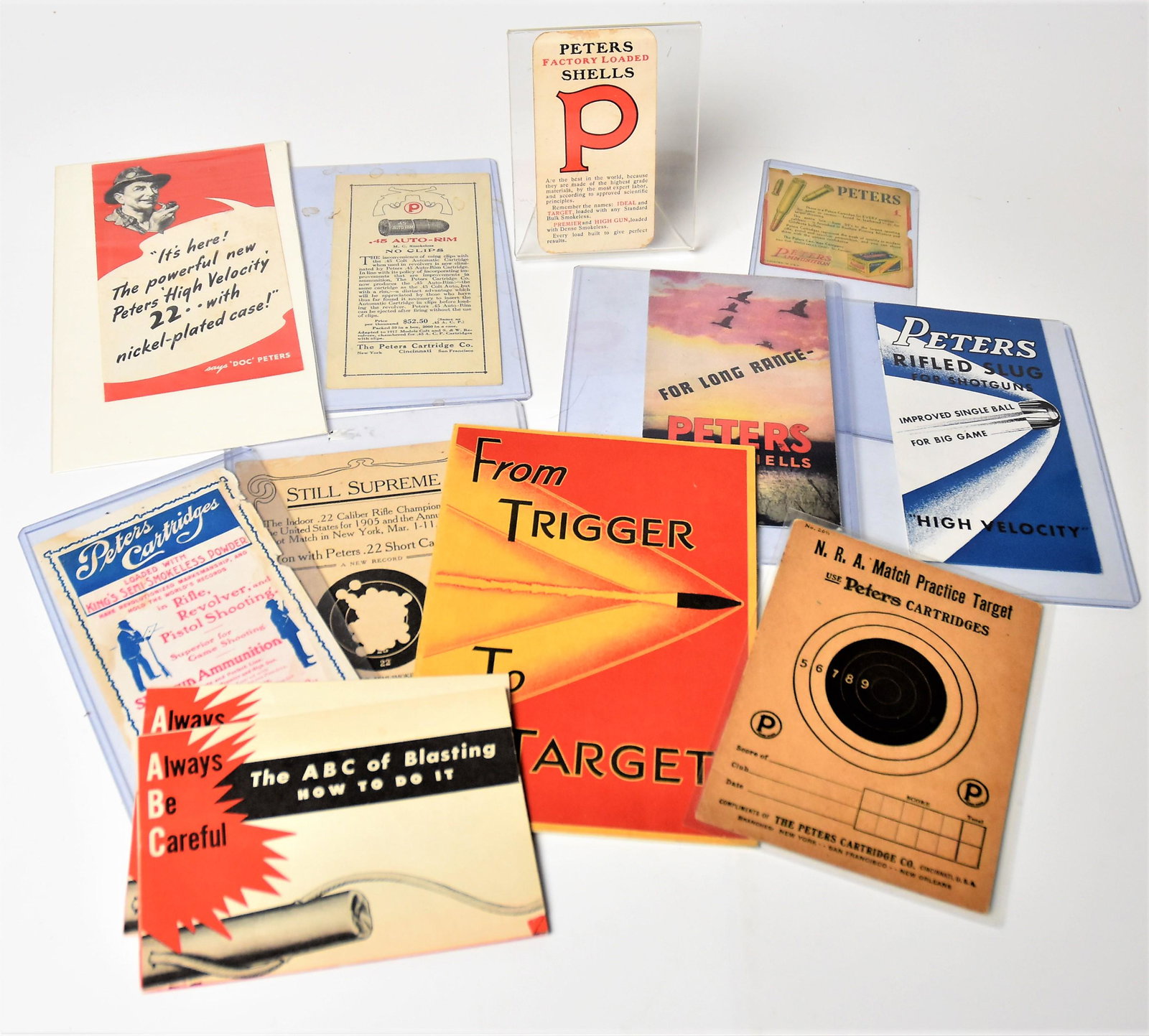 Peter Cartridge & Kings Powder Paper Ephemera: Lot of 12 including the following Peters items: two different card stock targets with advertising on reverse of each, one marked N.R.A. Match Target UsePeters Cartridges, 4 3/8 x6” & 4 1/2x 6 &#