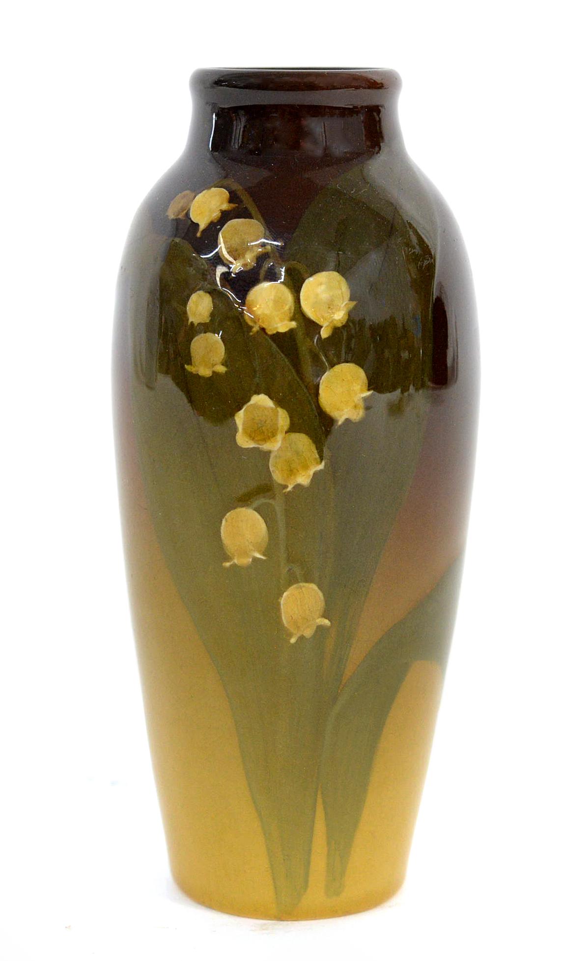 Rookwood Standard Vase by Elizabeth Lincoln: with Lily of the Vally painted by Elizabeth Lincoln. Marked with the company logo, 1901 date, 918 shape, and Ms. Lincoln's monogram. 5 3/4" High. Barely noticeable fine crazing.