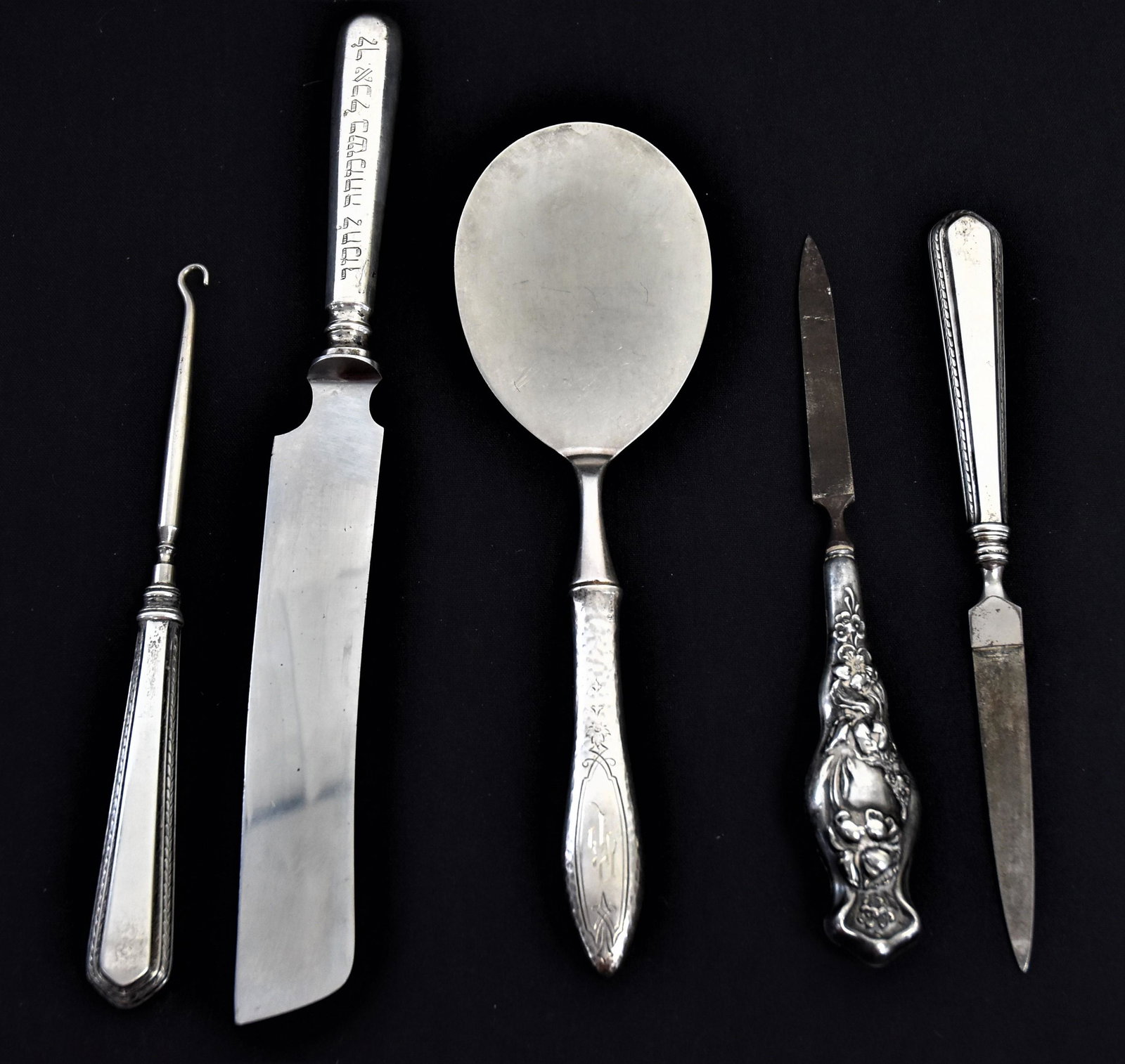 Sterling Handled Pieces: Lot of 5 pieces, including one pastry server which is all Sterling, total weight 2.38 ozt.; plus cake knife with Hebrew inscription on handle, 11” long; plus two different nail files, and a button h