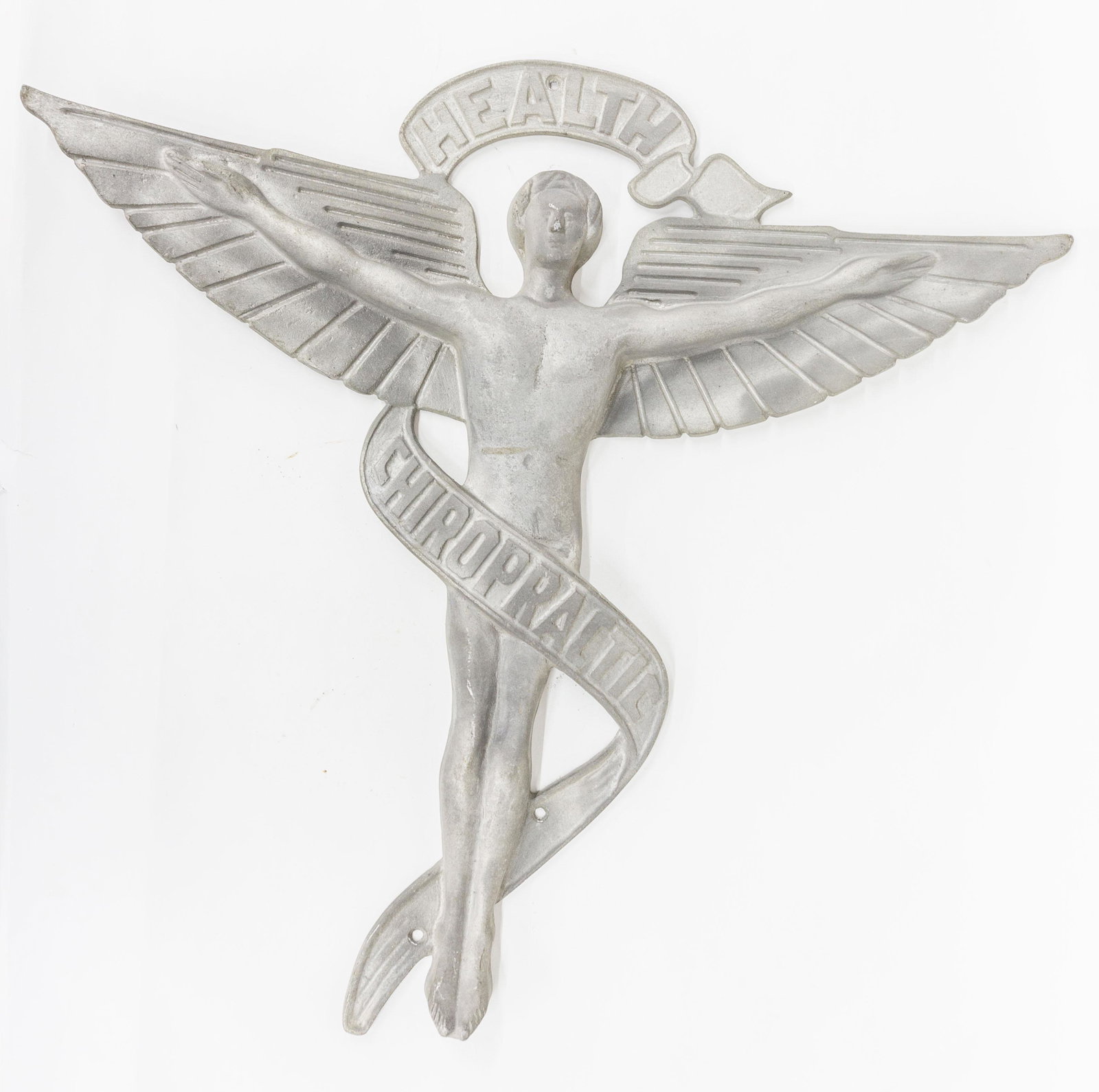 Figural Chiropractic Sign: Cast aluminum nude male figure with out stretched arms and wings with ribbon banner above and wrapping around waist with Health Chiropractic, 28 ½ x 27”. Condition Fine.