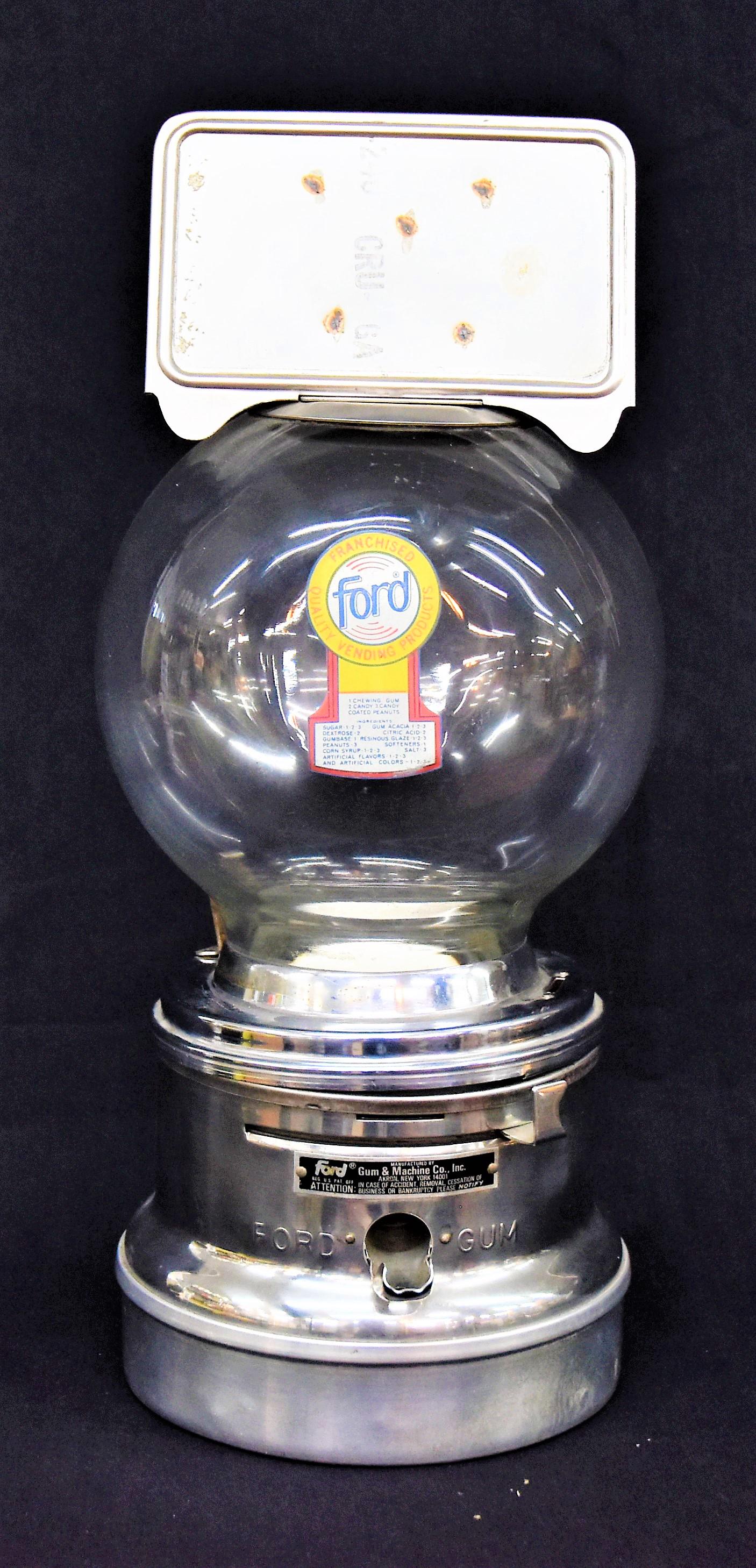 Ford Gum Ball Machine: Coin operated glass sphere, chromed steel and aluminum with spring loaded aluminum side mounted on top missing label, sphere with original polychrome decal, base with stamped aluminum label:Ford Gum M