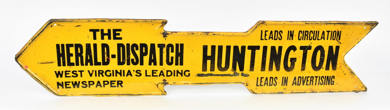 Herald Dispatch Huntington, WV Arrow Sign: Chromolithographed and stamped tin left pointing, text: The Herald Dispatch Huntington West Virginia Leading Newspaper Leads In Circulation Leads In Advertising, 27” x 6” high. Condition p