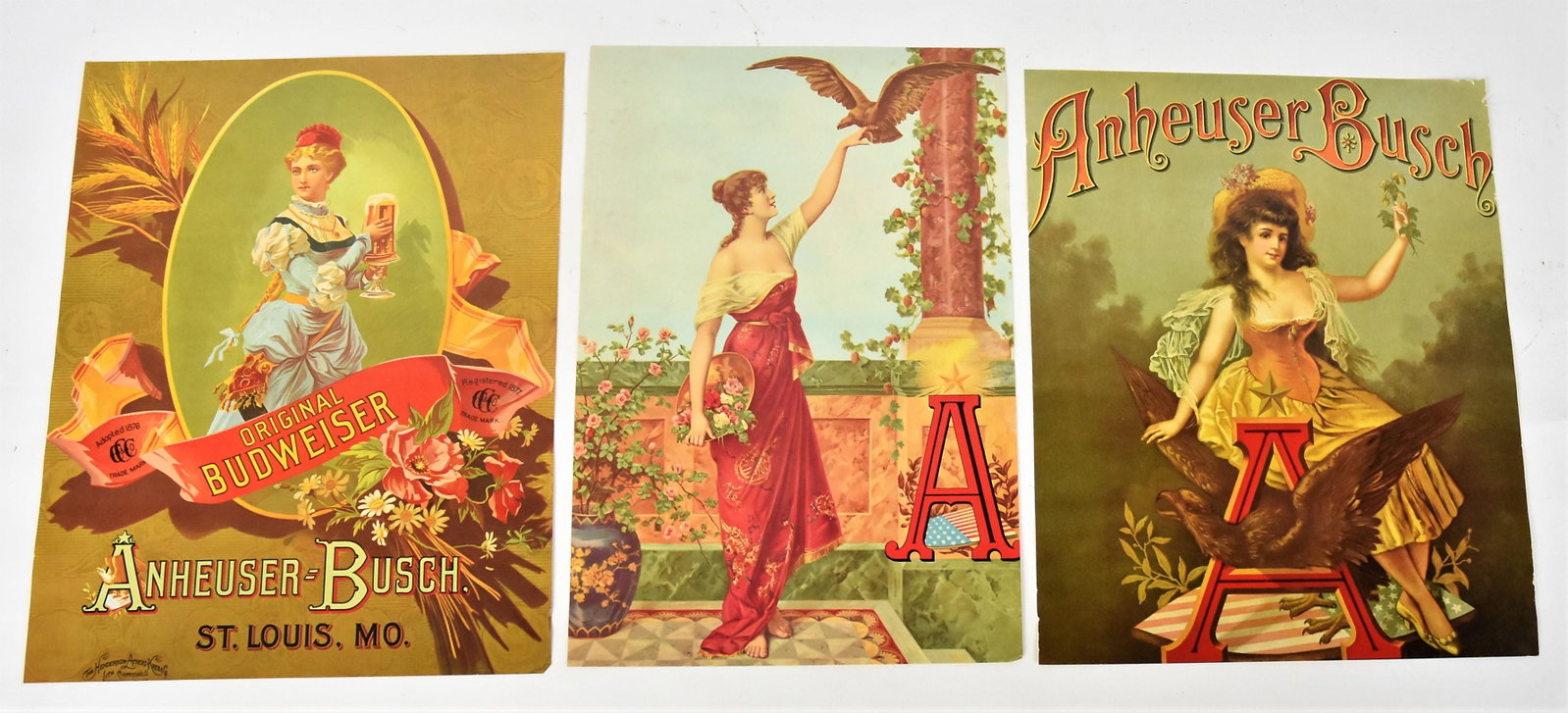 Anheuser Busch Chromolithographs: Lot of three, each with young lady, one with her arm outstretched with eagle landing on her hand, large red A with U.S. shield lower right in classical garden setting, 10 ¾ x 15 ¾”