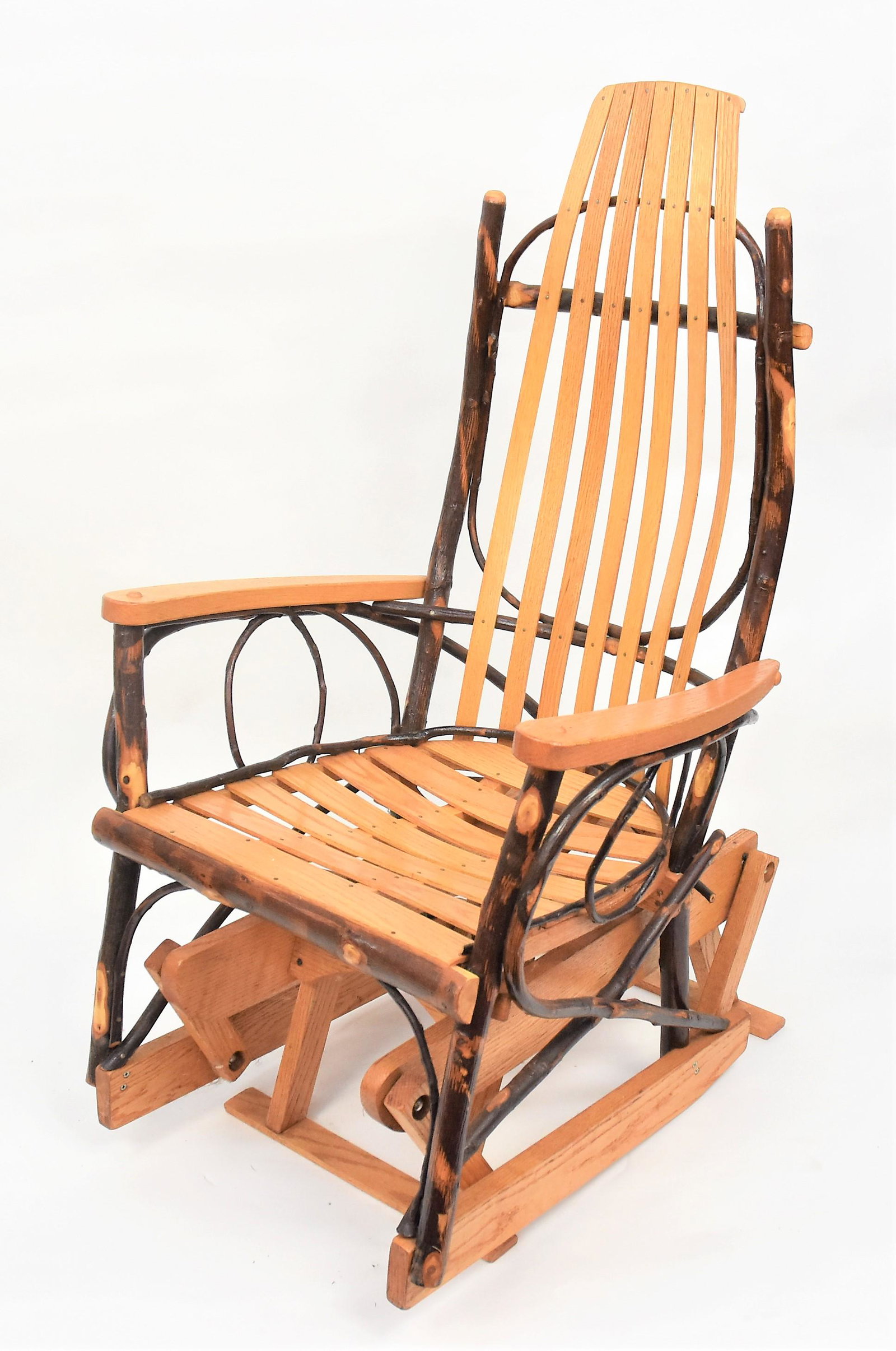 Adirondack Gliding Rocker: Mixed woods, primarily oak, 22 x 27 x 45" high, seat at 16 1/2". Condition Fine.