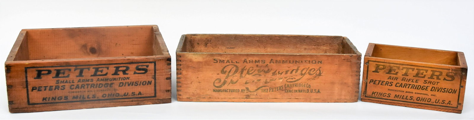 Three Peters Small Arms Ammunitions Crates: All wood with stencils on four sides, two marked Kings Mills, one Cincinnati, one dovetailed, including Air Rifle Shot; 22 Short and rim fire; 9 1/2 x 6 x 4 1/2" high; 14 1/2 x 12 x 4 3/" high; and 17