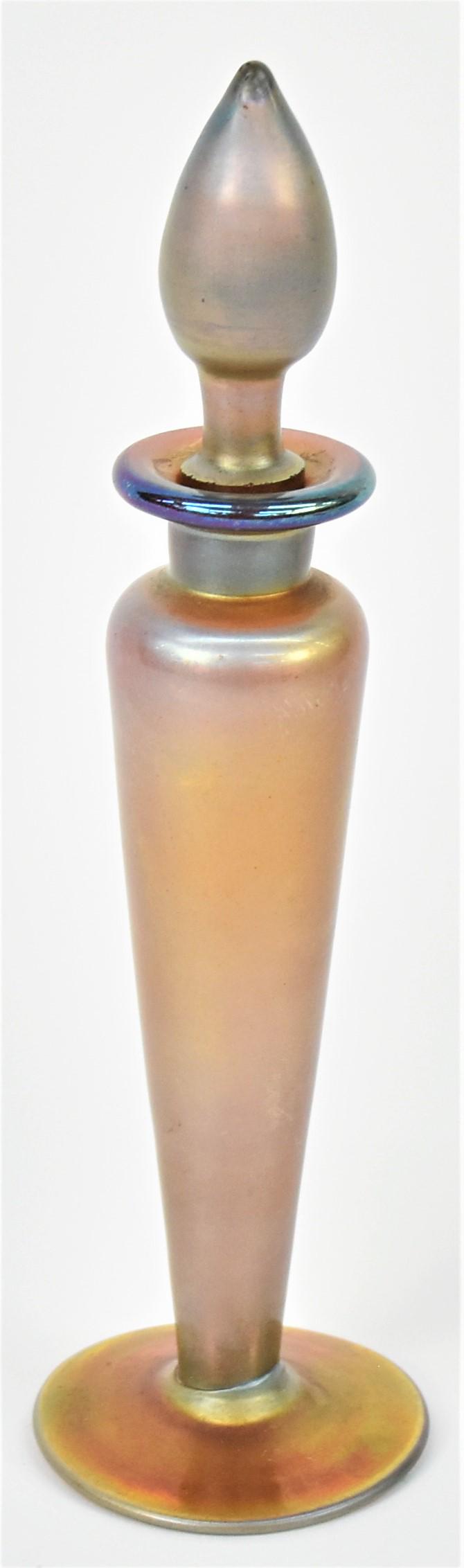 Steuben Aurene Perfume: Gold in baluster form with matching stopper and flared foot, signed on base aurene 1414, 7 3/4" high. Condition Fine.