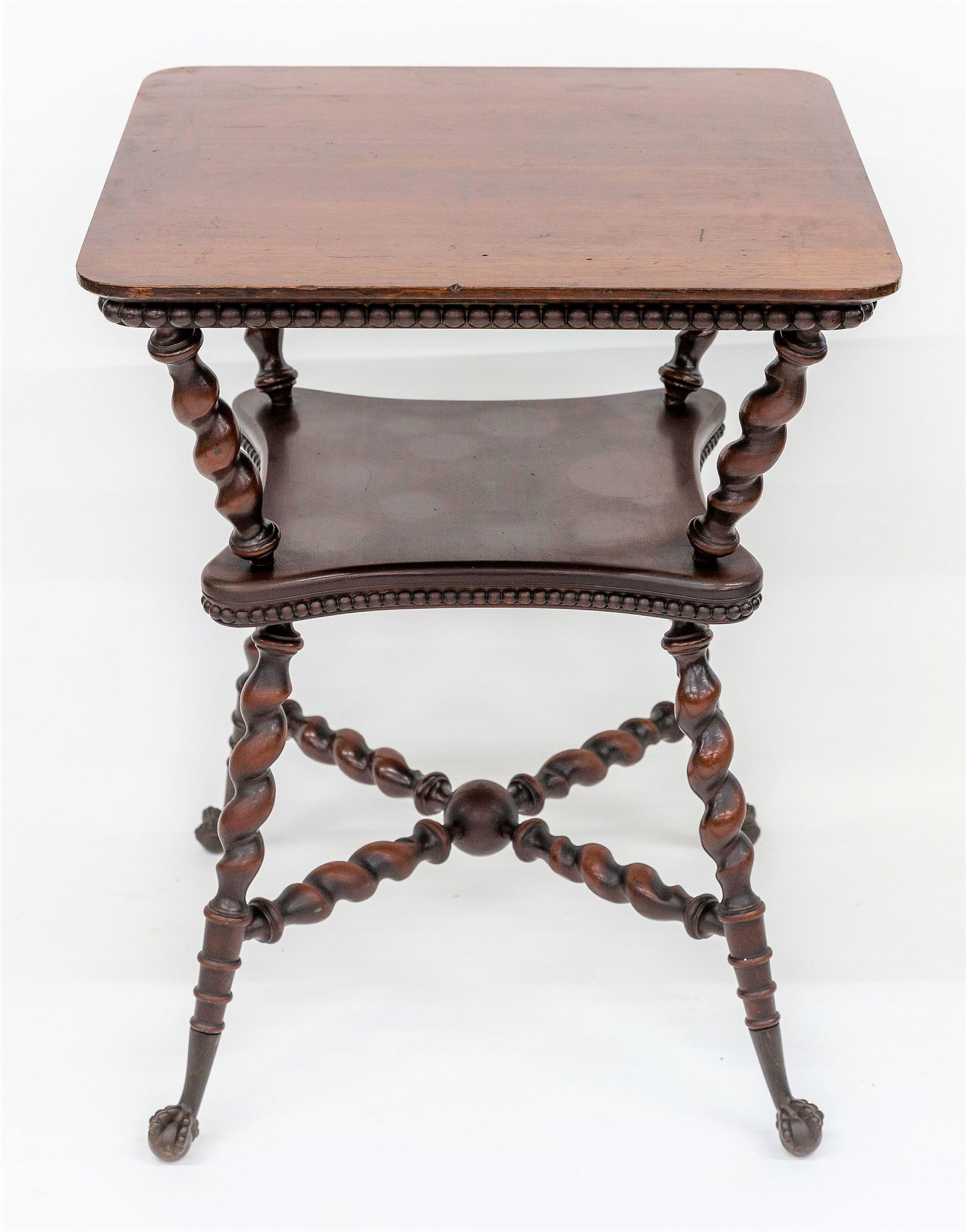 Marklin Bros. Cherry Lamp Table: Attributed, Victorian with square top with round corners with skirt having row of large beads, spiral turned legs with shelf and flared spiral turned legs with cast iron eagle claw & ball feet, in ori