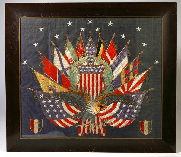 WWI PATRIOTIC SILK EMBROIDERED PANEL W/EAGLE: Depicting all thirteen of the allied flags crossed on blue silk with U.S. shield in center field with 13 five pointed stars above and spread winged bald eagle in foreground. Printed red, white, and bl