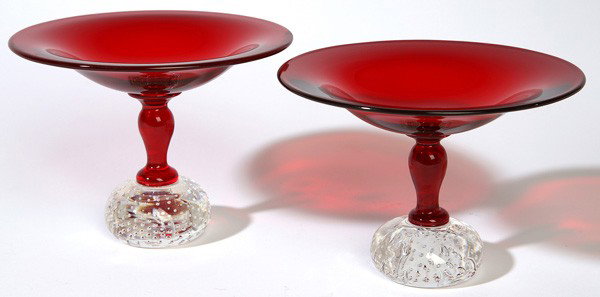 PR. PAIRPOINT ART GLASS TAZZAS: Both with 7" diameter ruby bowls and stems with clear air trap globular bases. Good condition. 5.5" high.