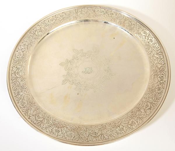 TIFFANY & CO. STERLING FOOTED CAKE PLATE: Circa 1910, Pattern #17266 which was first introduced in 1908. Flat rim with chased flowers and foliage and center with matching foliage and buds on a raised ring foot, marked on back "Tiffany & Co. 1