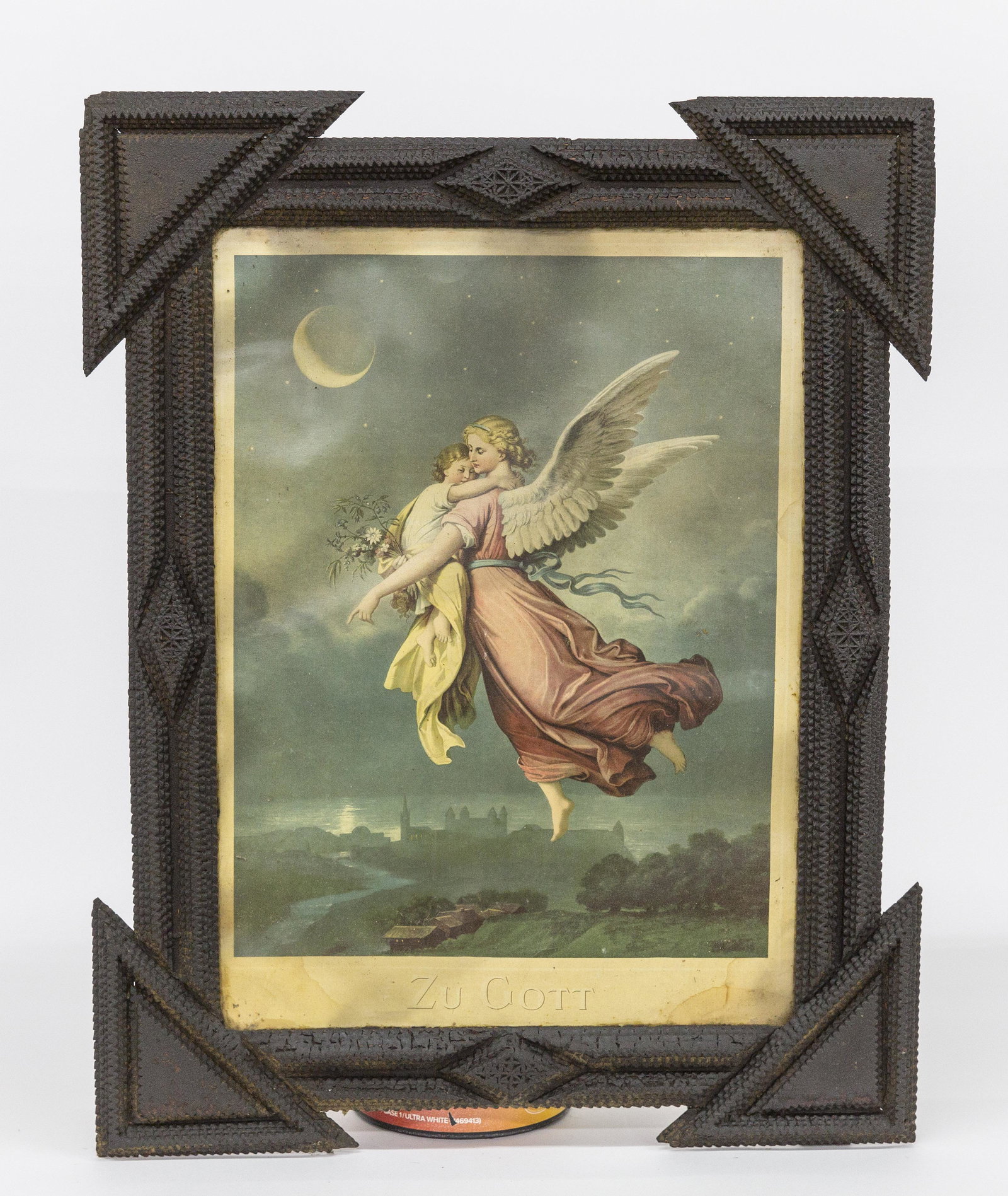 Tramp Art Frame: Circa 1880-90 with stepped chip carved in original heavy dark varnish finish with chromolithograph of Angel and child floating above landscape entitled below Zu Gott, 23 1/2 x 30". Condition minor edg