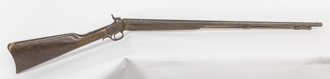 Early Percussion Shotgun: Unmarked, circa 1880, with 34" round 12 gauge barrel with top hammer, steel scroll trigger guard and steel butt plate and end cap, walnut stock and forearm, original ram rod, nice brown patina, 49" lo