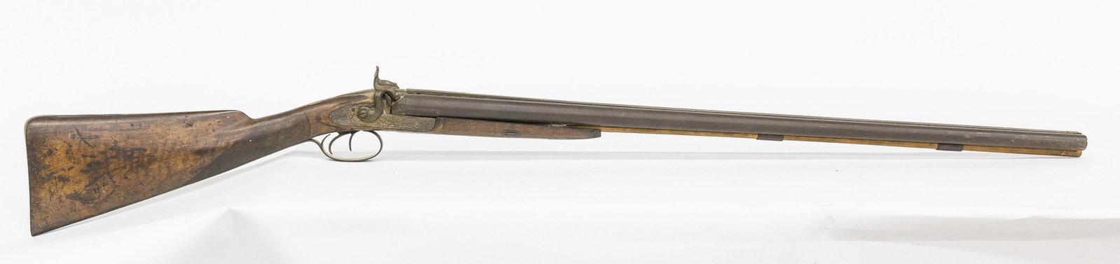 Early Double Barrel Shotgun: Percussion 12 gauge with unmarked round 33 1/2" barrels, floral engraved lock plates and hammers, steel trigger guard, ram rod sleeves both with fine floral engraving and steel butt plate, walnut stoc