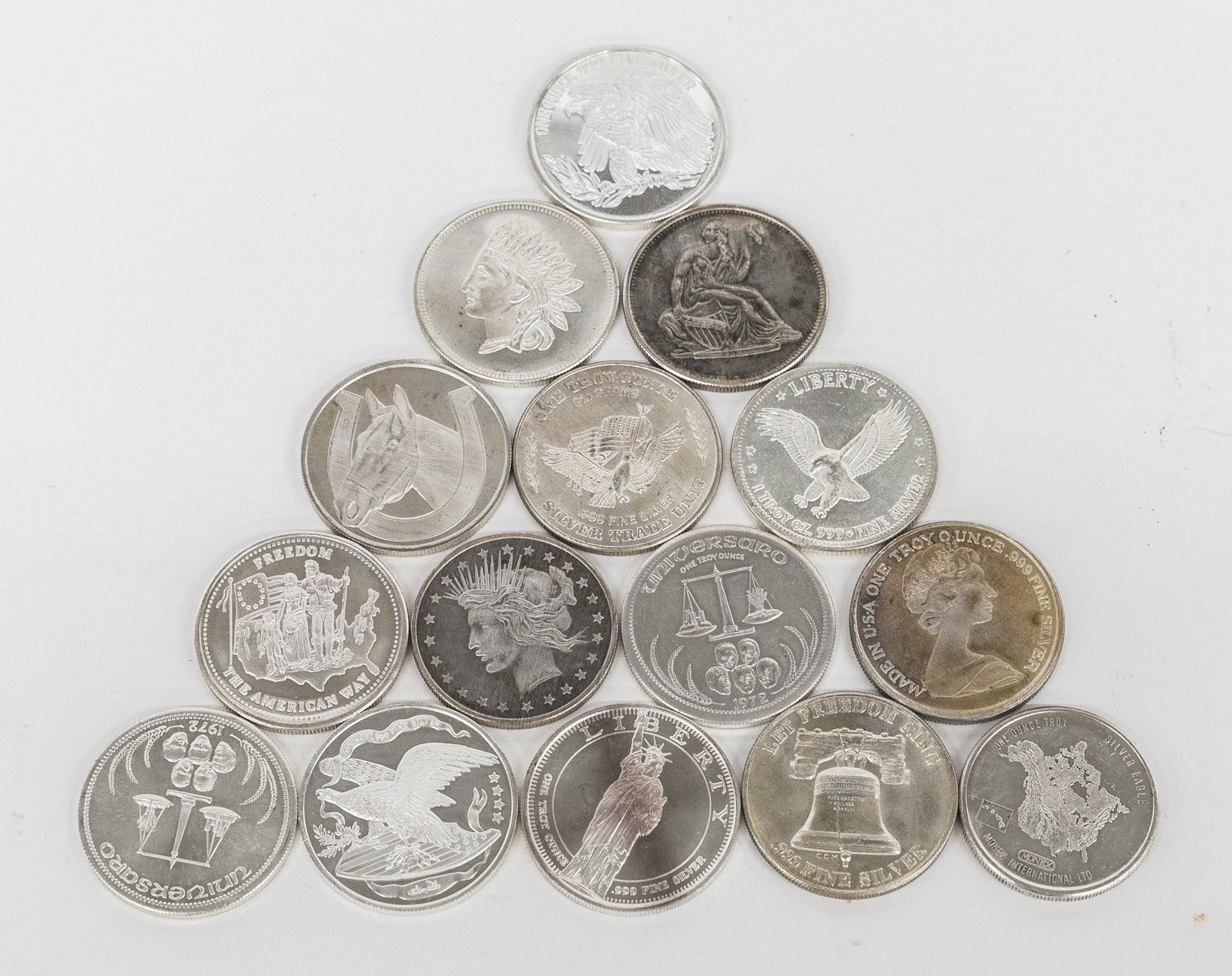 Fifteen Silver Bullion Coins: All one troy ounce, .999 fine silver, including one 1987 Canada Maple Leaf; plus one John Matthey Cincinnati; plus two Universaro 1972; and 11 others. 15 ounces troy silver. Condition all uncirculated