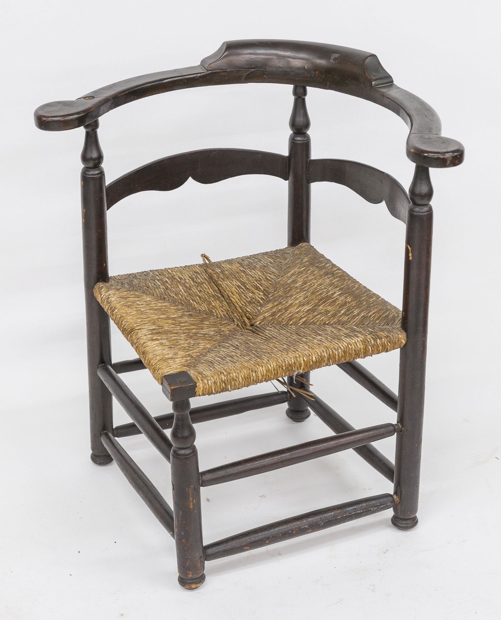 Early American Corner Chair: Mixed woods, circa 1800 with old dark finish, turned posts and legs, rush seat, 28 x 24 x 30" high, seat at 15 1/2". Condition crack in one arm, else VG.