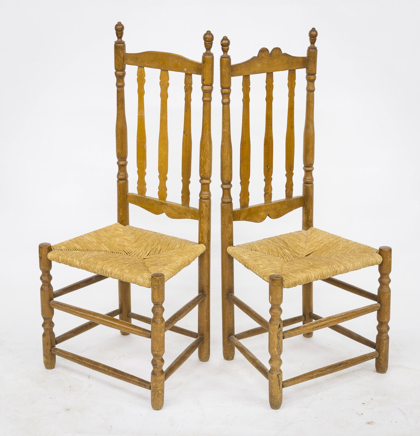Pair American Banister Back Chairs: Maple circa 1740-60 with nicely turned rear posts with finials, cut-out crest and three half turned slats, rush seats, sausage turned legs with double stretchers on front and sides, 18 1/2 x 13 1/2 x 