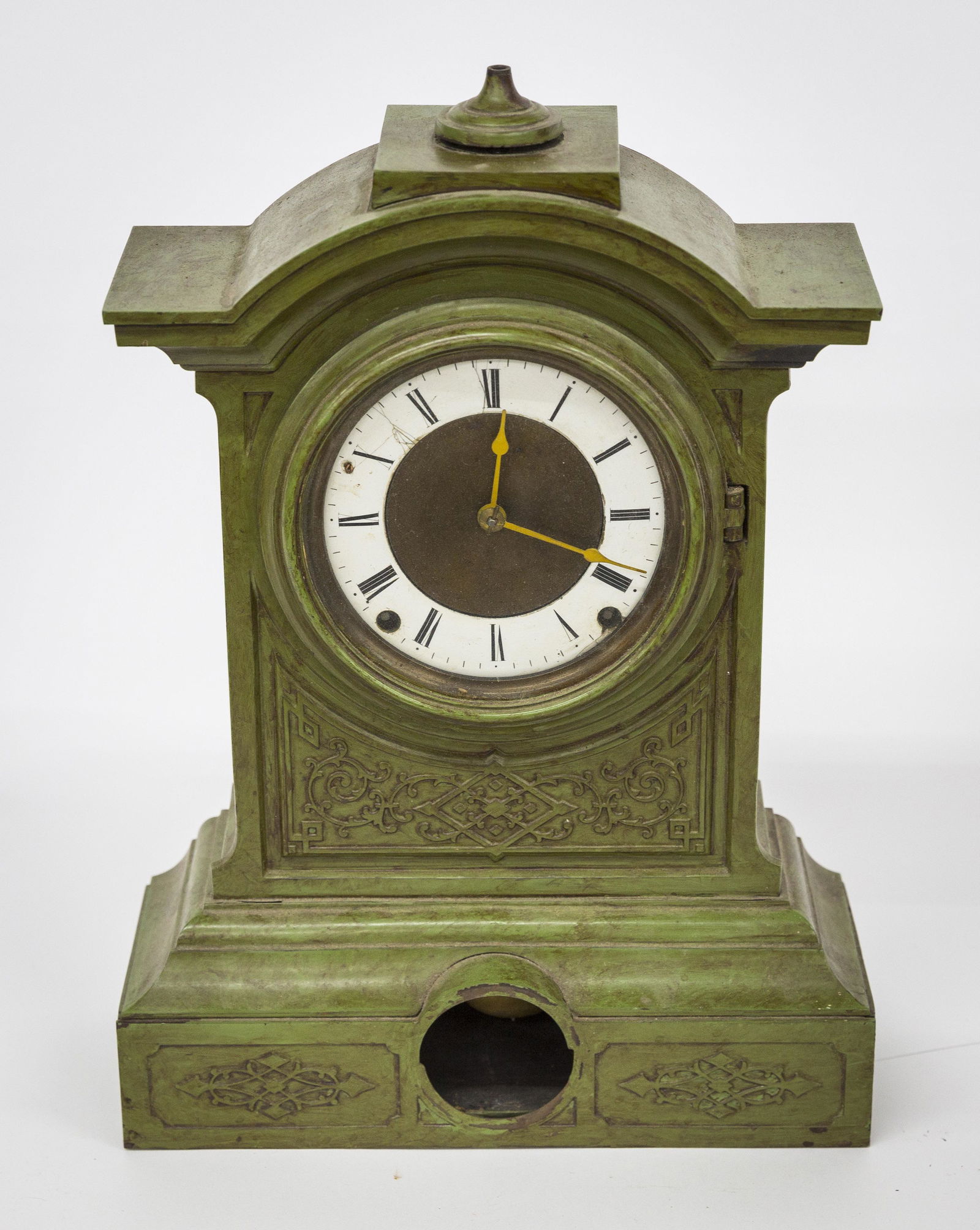 Seth Thomas Cast Iron Shelf Clock: Enameled dial with Roman numerals in cast iron arch top case with missing finial in green bronzed painted finish, unusual brass spring driven 8-day time & strike movement stamped Seth Thomas Plymouth
