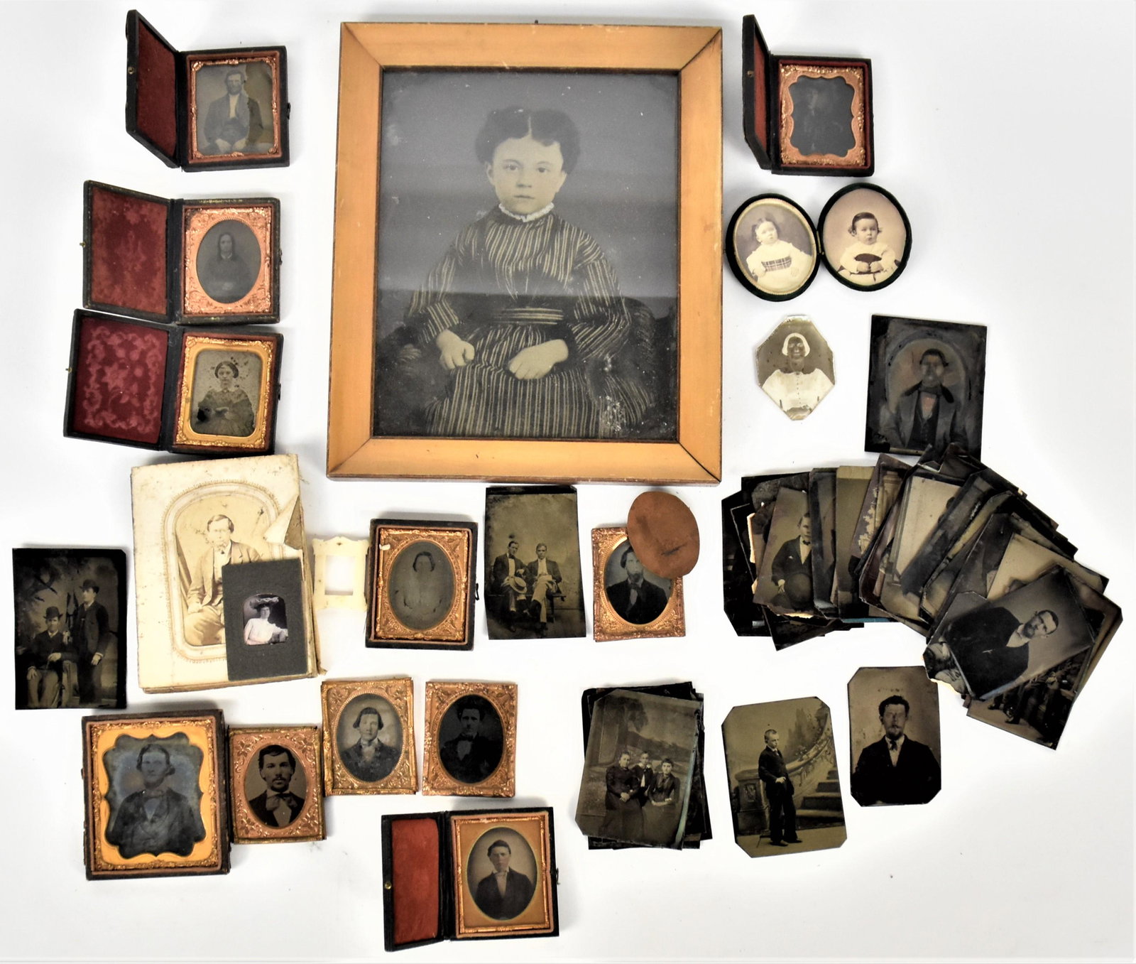 Early Photography Lot: Lot includes one 16th plate oval daguerreotype of lady; plus ambrotype of man in half 9th plate case; plus 3 other ambrotypes portraits; plus five 9th plate cased tintypes in full cases; plus oval vel