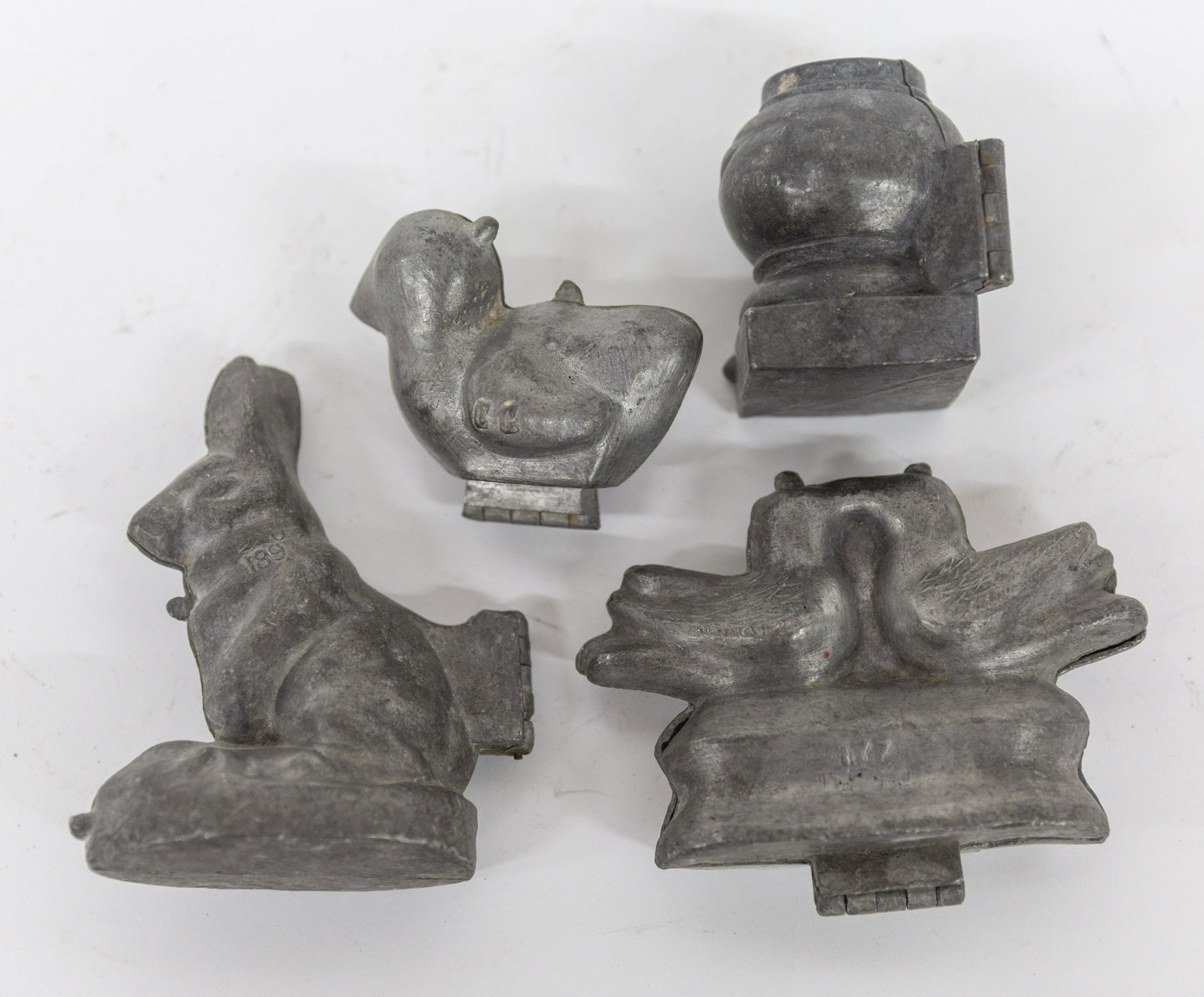 Four Pewter Ice Cream Molds: Including seated rabbit, marked S & Co. 189, 4 x 2 x 5" high; plus love birds, marked 177, 5 x 1 1/2 x 4" high; plus Easter chick, marked CC 1011, 3 x 2 x 3" high; and capstan form decorated with bird