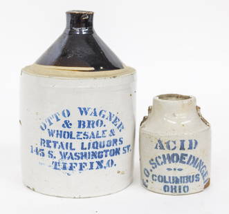 Blue Stenciled Ohio Stoneware: Lot of two including brown and white glazed half gallon jug with blue stenciled Otto Wagner & Bro. Wholesale & Retail Liquors 145 S. Washington St. Tiffin, O. with C scroll handle, 6" diameter x 9" hi