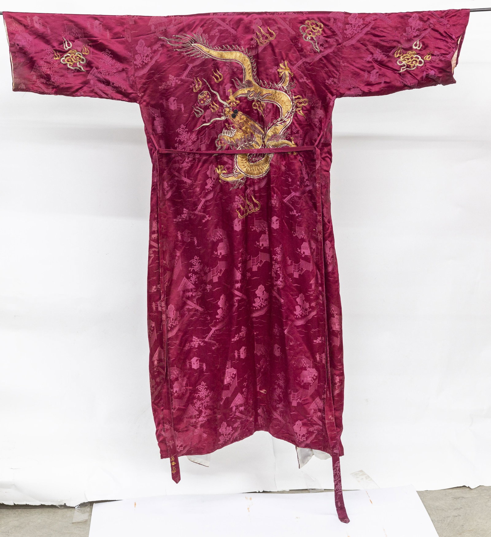 Chinese Silk Robe: Early 20th century, one in red with embroidered gilt five toe dragons, with matching belt, white silk liner, 59" long; . Condition Minor wear, VG; 2nd right arm needs seam resewn.