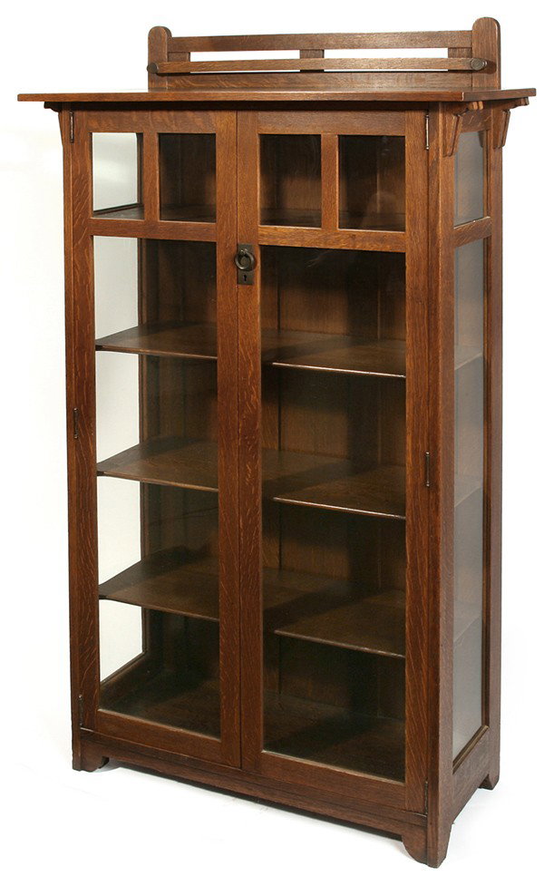 STICKLEY BROTHERS 2- DR. CHINA CABINET: In the form of #8745 with plate rack; splined overhanging top supported by corbels; adjustable shelves; excellent medium brown original finish. Numbered. Unsigned. Excellent condition. 66" H x 36" W x