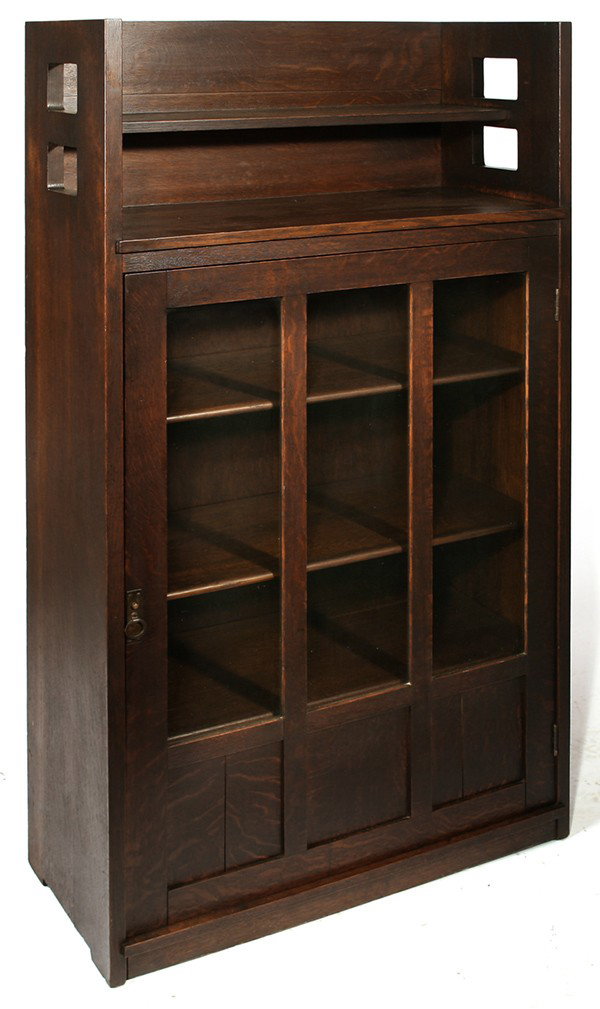 EARLY LIMBERT CUT-OUT SINGLE DOOR BOOKCASE: With galley top; adjustable shelves; excellent original dark red brown finish. Signed with early paper label. Very good condition. 64" H x 32" W x 14 1/2" D.