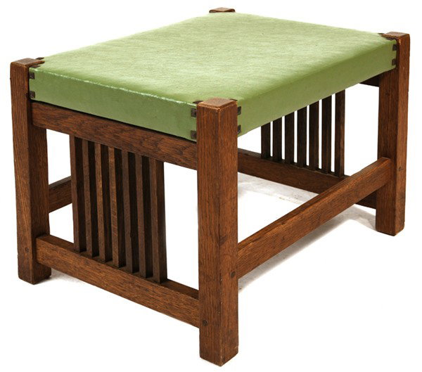 GUSTAV STICKLEY SPINDLED FOOTSTOOL #395: Fine older refinish; replaced leather with original tacks. Very good condition. 15" H x 20" W x 16" D.