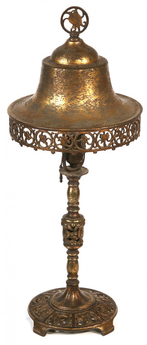 OSCAR BACH TABLE LAMP: With pierced floral and leaf designs to shade; bird designs to finial and base. Signed with "Oscar Bach, New York Studios" metal tag. Original patina. Good condition. 25 1/2" H x 10" dia. Shade.