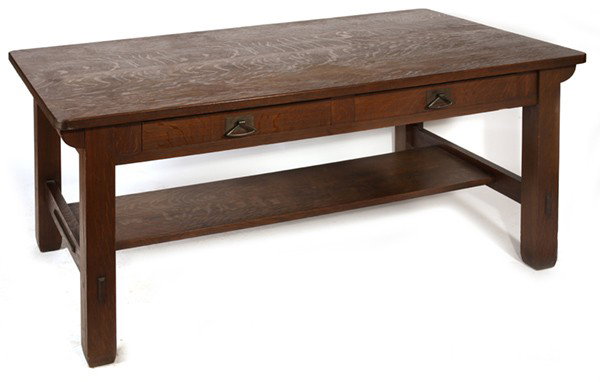 MASSIVE STICKLEY BROTHERS LIBRARY TABLE: With splined top supported by corbels and 2-drawers with thru-tenons on lower shelf; very good original medium brown finish. Few stains to top. Very good condition. 30" H x 66" W x 36" D.