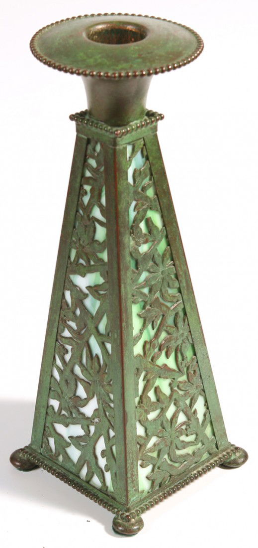 APOLLO STUDIOS NEW YORK CANDLESTICK: In style of Tiffany; with pierced floral panels lined with green glass. Original patina. Unsigned. Good condition. 8" H.