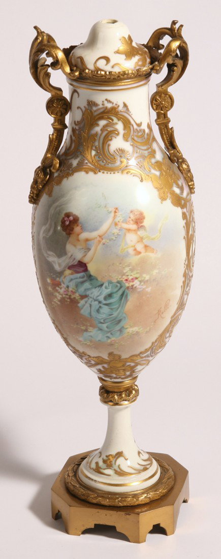 FINE SEVRES BRONZE MOUNTED URN: With scene of Venus and Cupid, gilt highlights with blue painted Sevres mark. Bronze marked "France". Damage to lid; otherwise excellent. 17" high.
