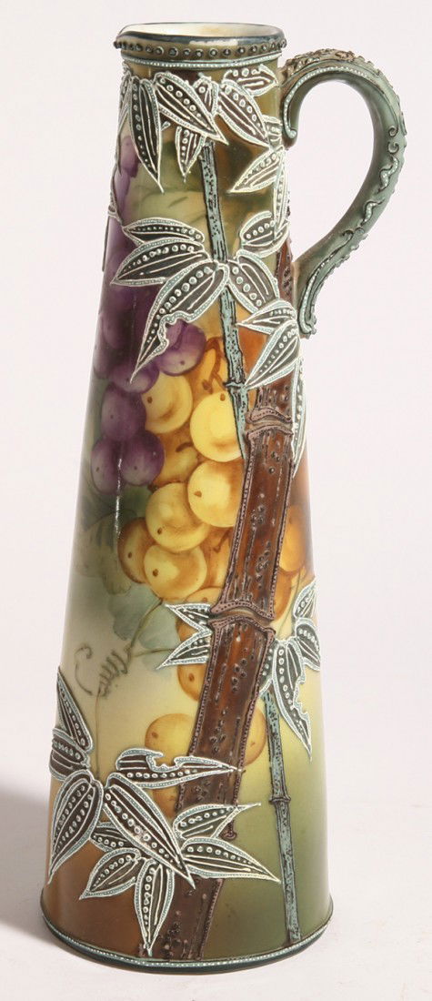 NIPPON MORIAGE EWER: Painted with grapes and leaves and moriage bamboo over top, marked on base "Handpainted Nippon" with maple leaf in green. 11.25" high. Short line at lip.