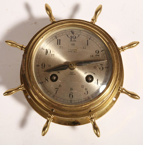 SALEM SHIPS BELLS BRASS CLOCK: Marked on silvered dial "Salem Ships Bell 8-Day Jeweled" and on back "Salem Clock Co. Hartford, Conn. Jeweled - 8-Day Made in USA", with key. 6" diameter.