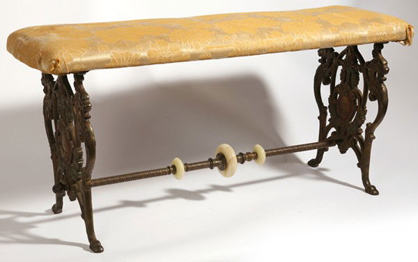 CAST IRON BENCH: With winged griffins and stylized floral design in original bronzed and painted finish. Circa 1910. 12" x 40" x 18" high.