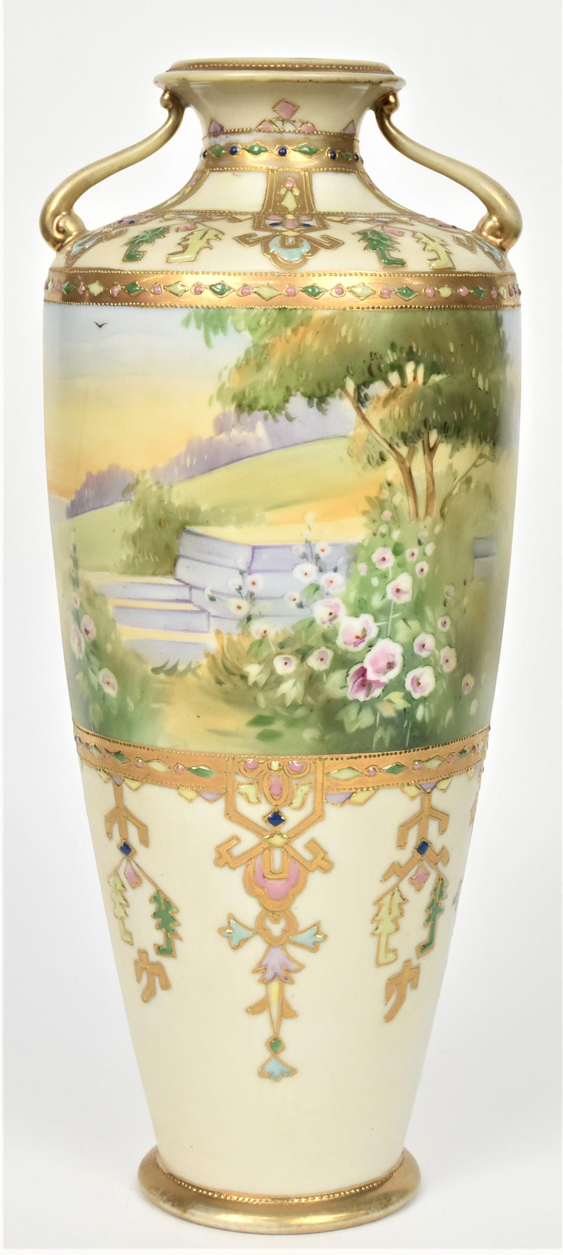 Nippon Handled Scenic Vase: A summer garden surrounding steps. Decorative and colorful enamel jeweled designs on the shoulder and lower body. 13 1/2" tall. M in wreath backstamp. Hard to find. Crows foot to base, otherwise good 