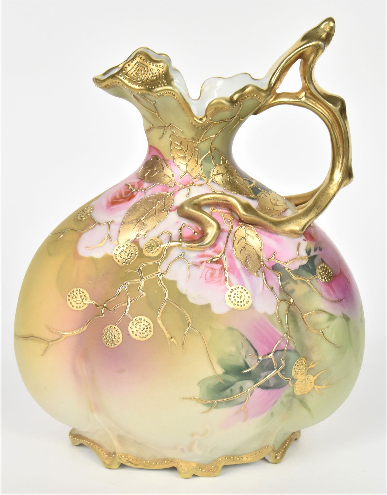 Nippon Melon Ribbed Ewer: With gold irregular rim and scroll vine handle. Bouquet of pink roses front and back overlaid with raised gold berried vines. 9" tall handle to tip. Maple Leaf backstamp. Charming and in good conditio