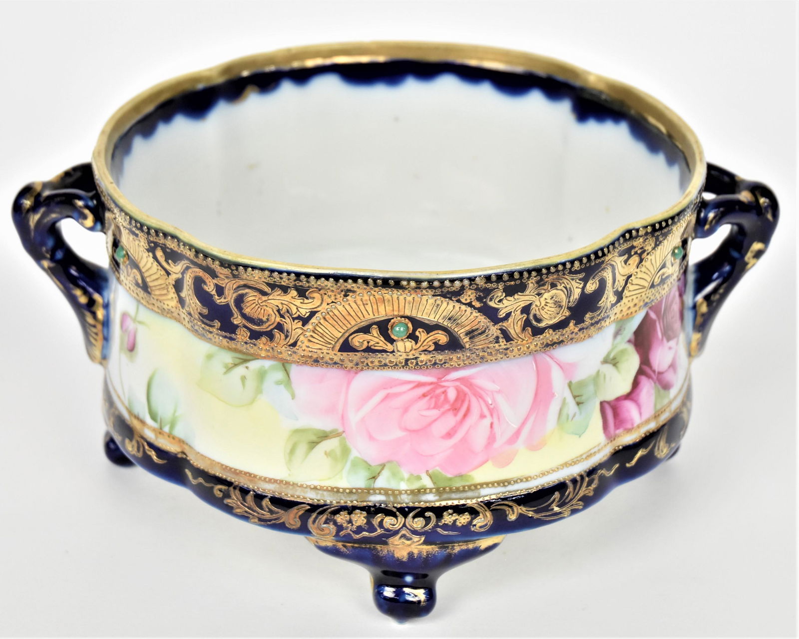 Nippon Cobalt and Jeweled Fernery: Featuring ruby and pink roses. Ornate raised gold trim. Wishbone handles, four feet. 4 1/2" tall, 9 1/2"across handle to handle. Maple leaf backstamp. Good condition.
