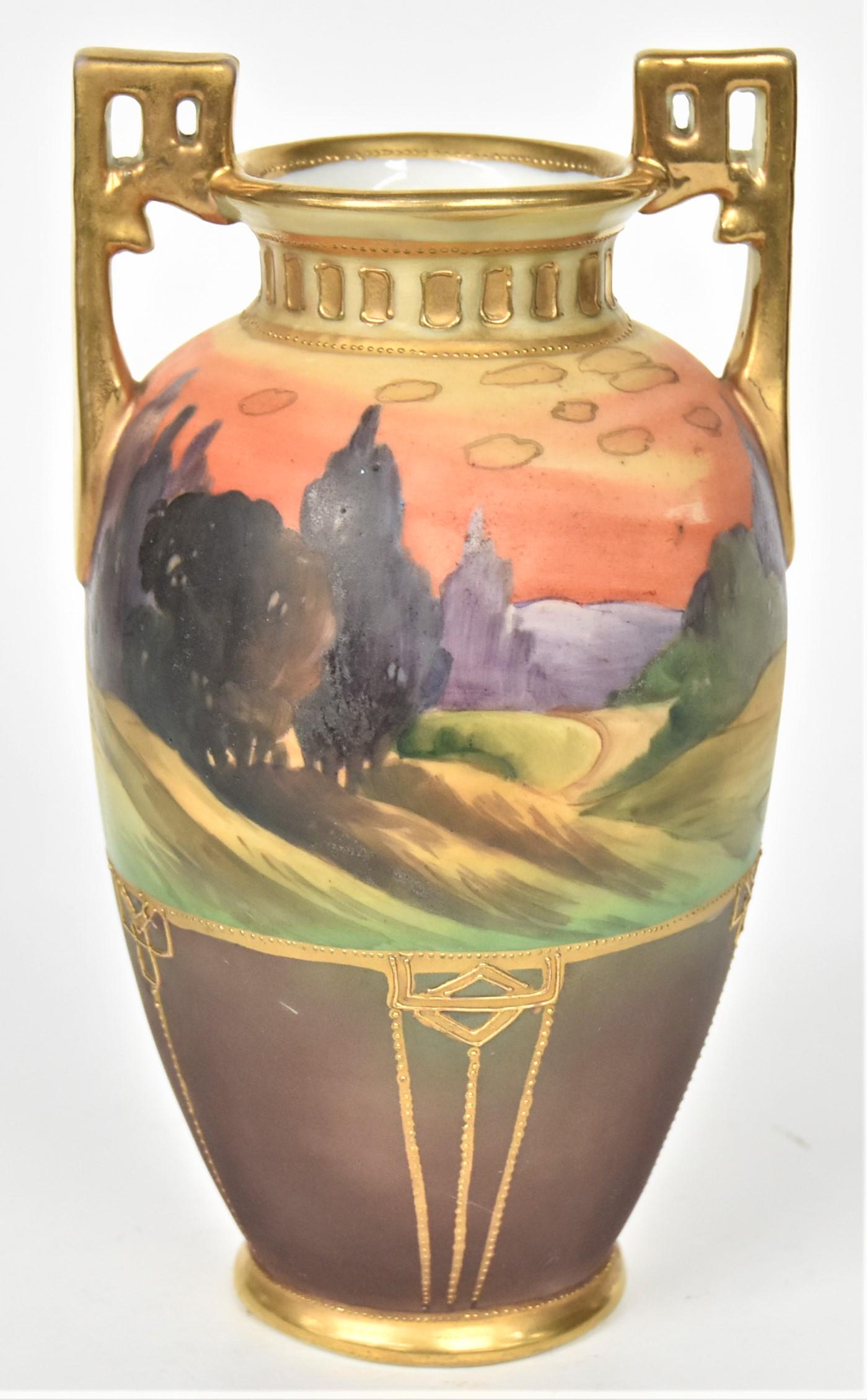 Nippon Scenic Vase: Colorful cypress tree landscape at eventide. Gold pierced handles, raised gold trim. 7 3/4" tall, 4 1/8" handle to handle. M in wreath logo. Good condition.