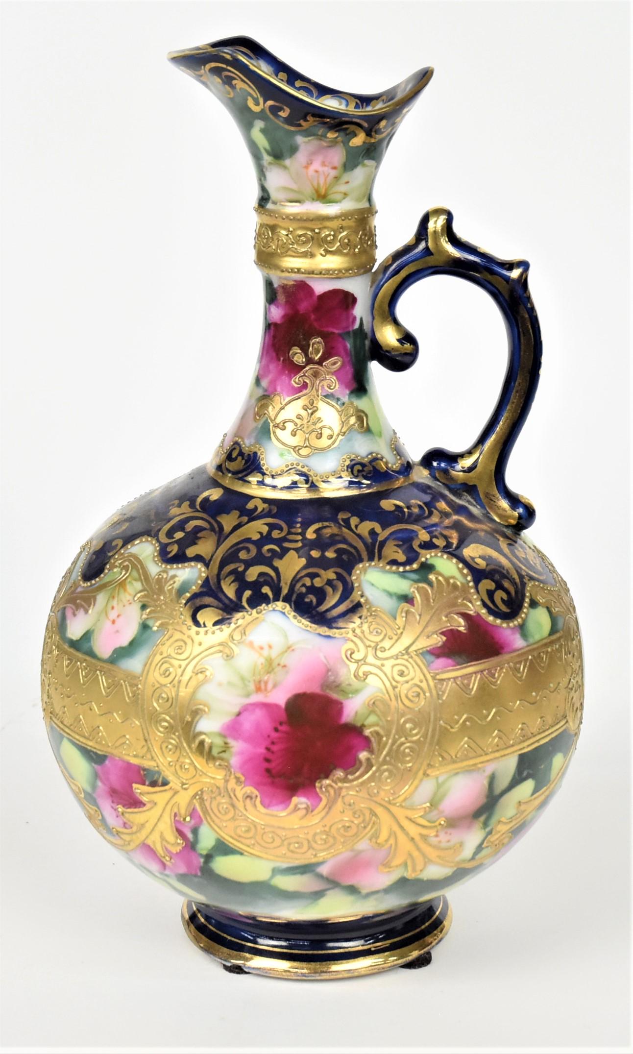 Nippon Cobalt and Wild Roses Ewer: Enhanced with raised gold and golden scrolls. 9 1/4"tall, 5 1/2" across. Unmarked Handsome and in good condition.