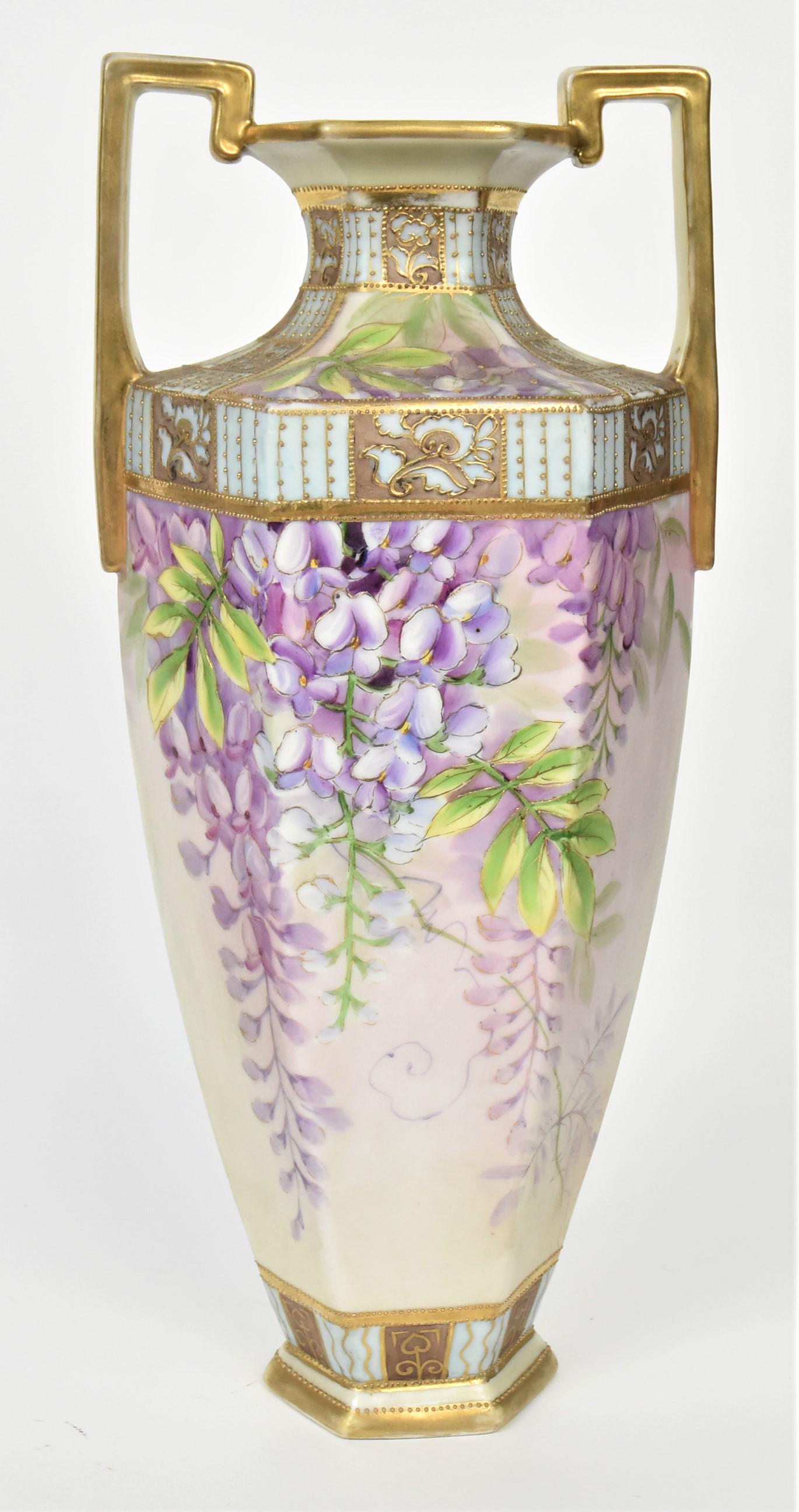 Tall Nippon Hexagonal Handled Vase: Displaying lifesize wisteria pods enhanced with raised gold and painted borders. 14 1/2" tall, M in wreath logo. Impressive and in good condition.