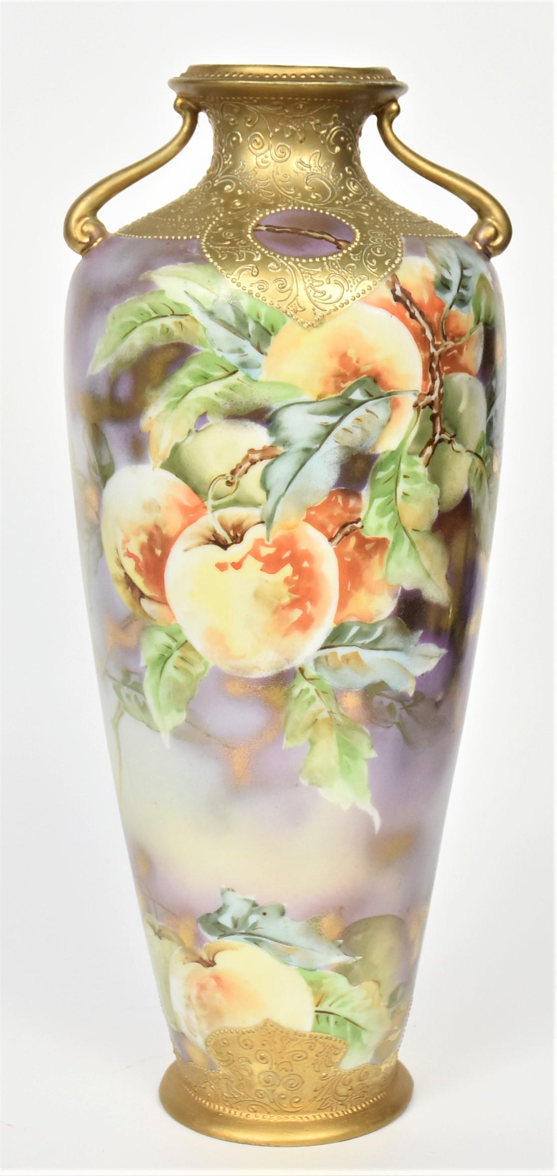 Tall Nippon Apple Branch Vase: With decorative raised gold collar and base. 13 1/2" tall, maple leaf backstamp. After factory unfired gold on rim, handles and base. Not often seen design. Otherwise good condition.