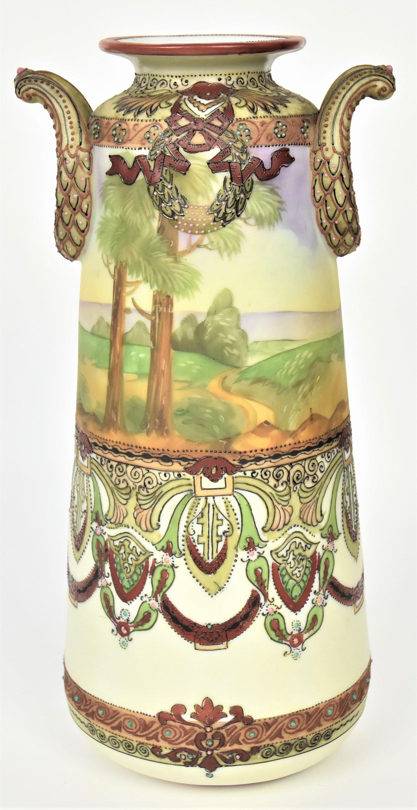 Nippon Enamel Beaded Landscape Vase: Featuring decorative wreath handles, elaborate painted and enamel designs border a colorful country landscape. M in wreath logo, 11 3/4" tall. Impressive vessel in very good condition.