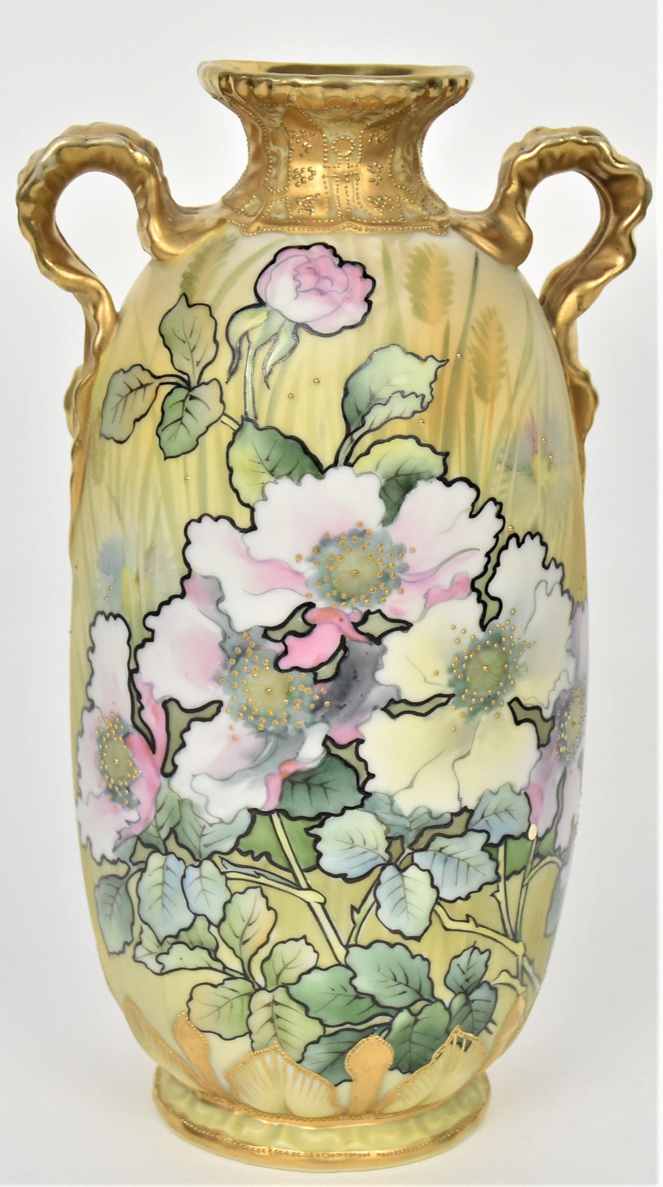 Nippon Poppy and Cornflower Vase: Having gold ruffled leaf handles and decorative raised gold on collar. Relief leaves and buds at base highlighted in gold. M in wreath logo, 9 3/4" tall handles. Attractive and in good condition.
