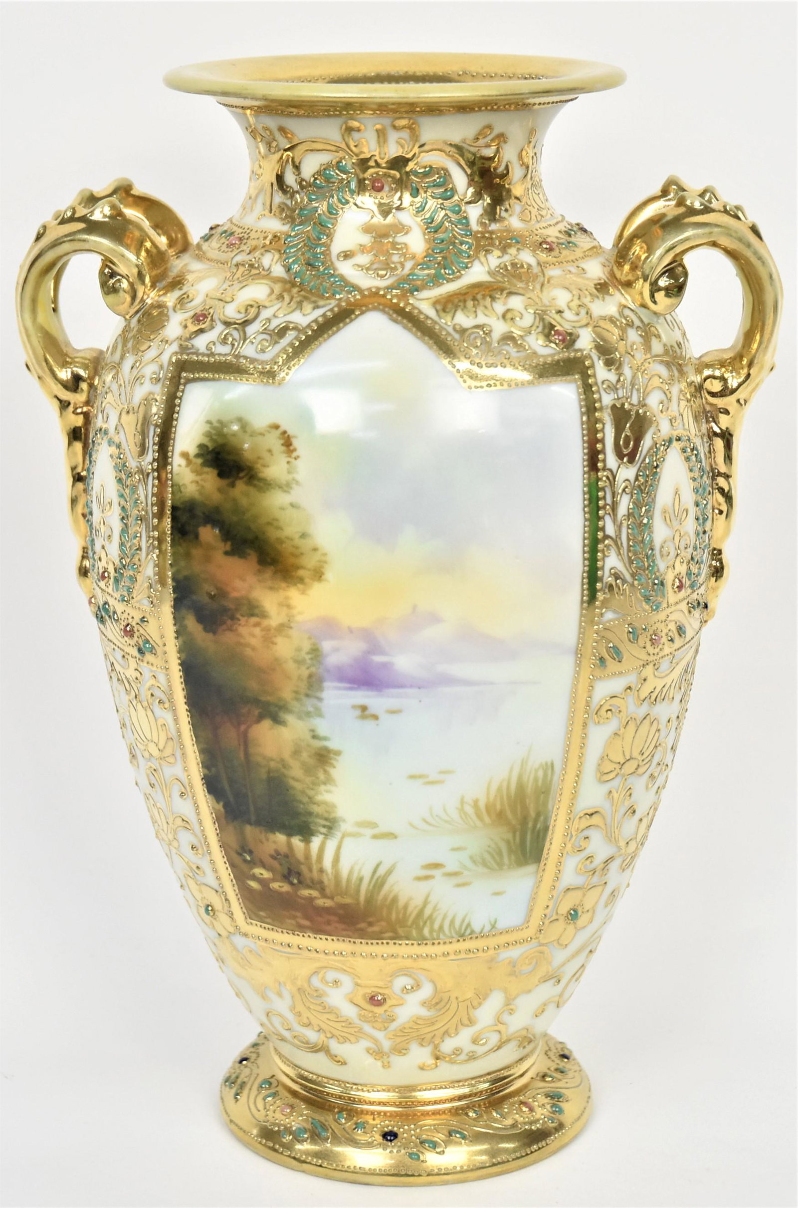 Nippon Jeweled and Scenic Vase: Elaborately decorated in raised gold florals and leafy vines accented with colorful enamel jewels. Scenic panels front and back. Gold wishbone handles. 10" tall, maple leaf logo. Impressive and in goo