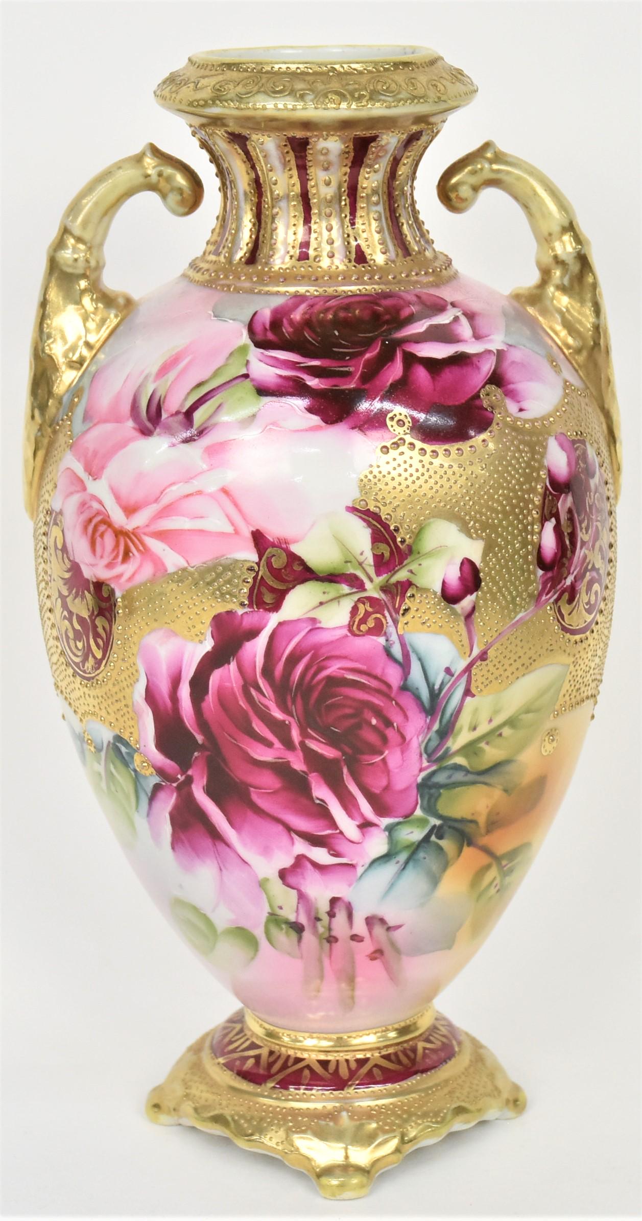 Nippon Ruby Roses and Gold Overlay Vase: The bold floral arranged are all around highlighted with extensive bright raised gold. Acanthus leaf molded handles. 10 1/4" tall, unmarked. Attractive and in good condition.