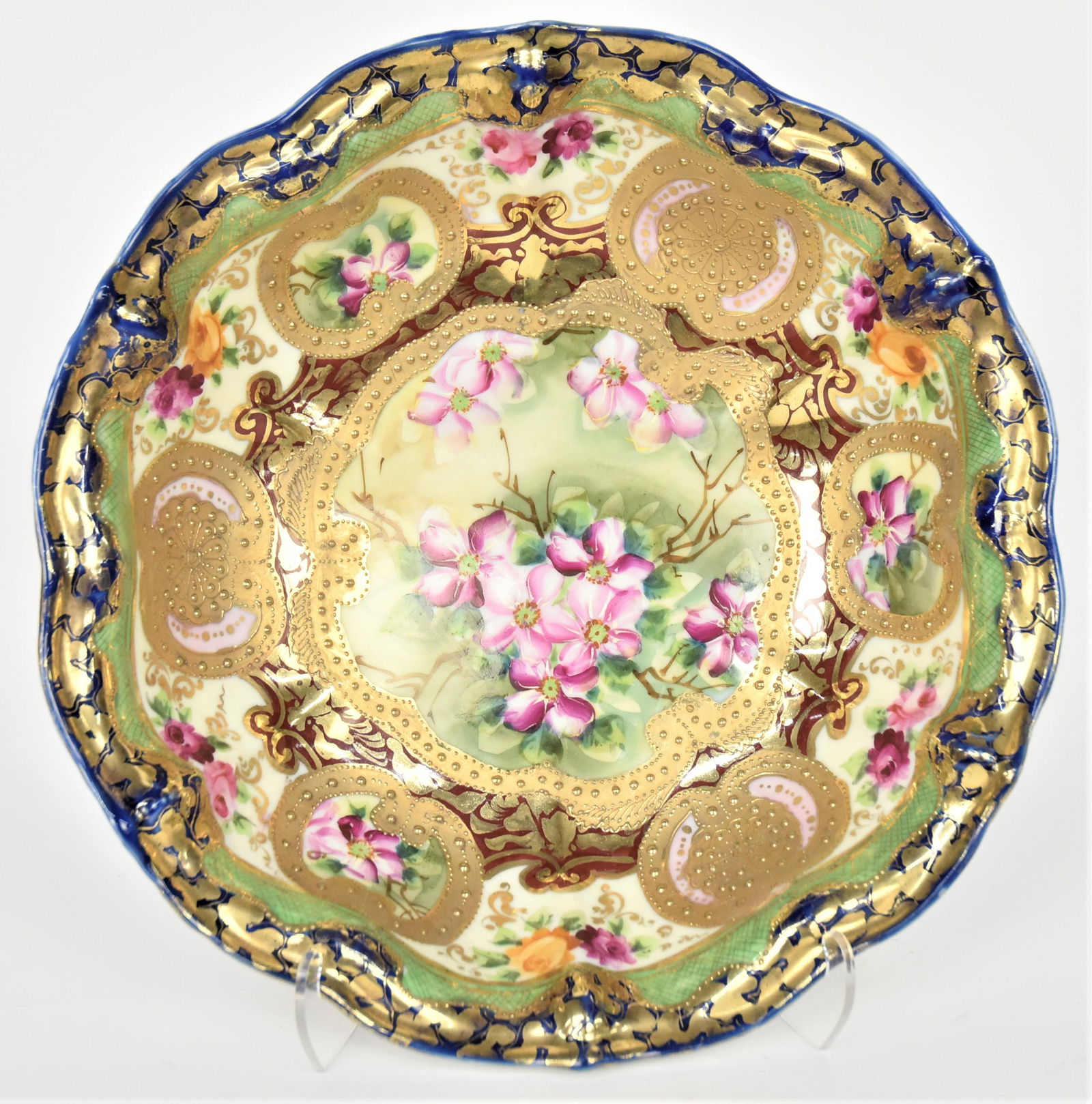 Nippon Cobalt Decorative Bowl: Bright Gold beading accents assorted florals, 3"tall and 10 1/2" diameter. Maple leaf logo. Impressive and in good condition.