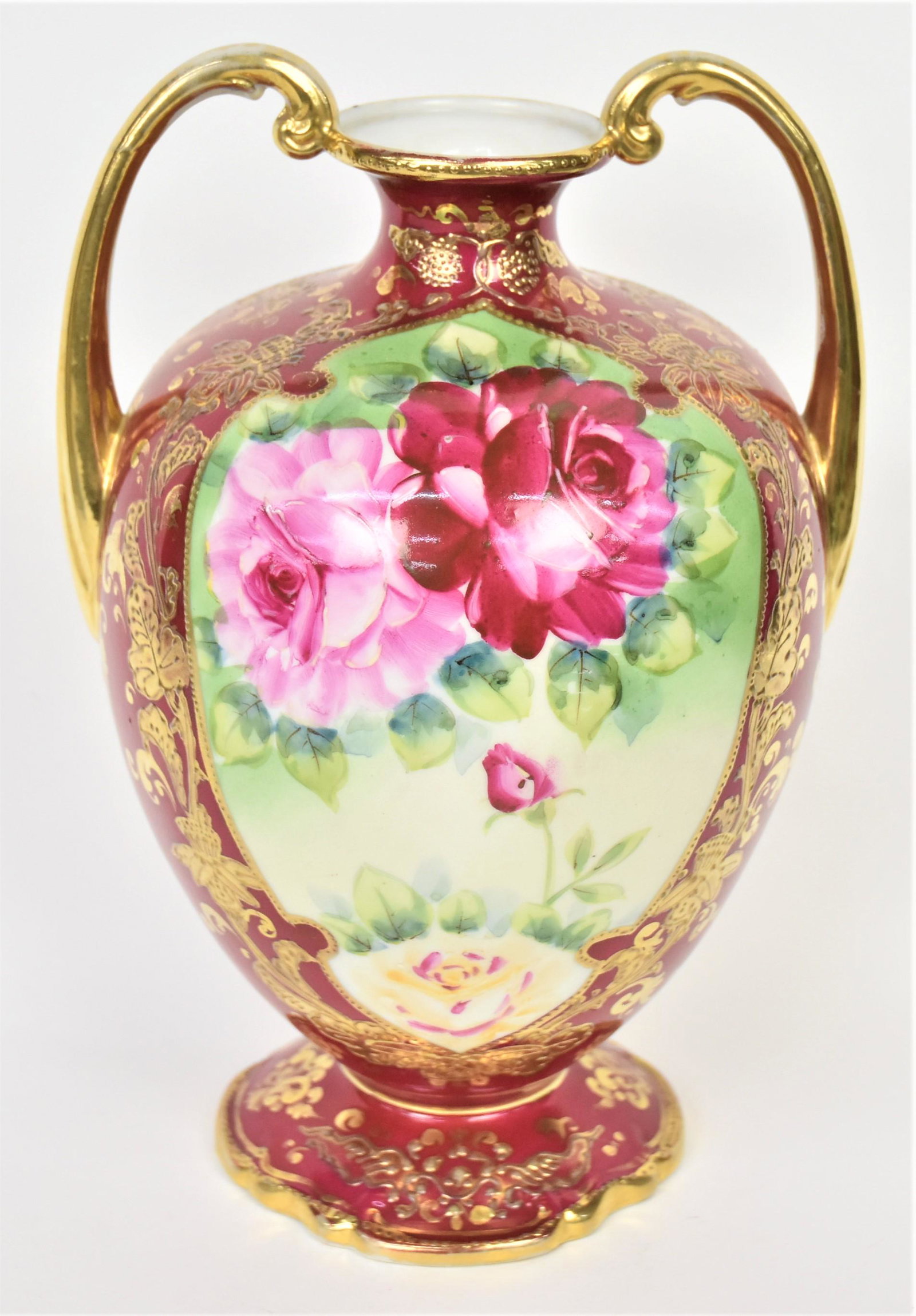 Royal Kinran Nippon Handled Vase: Featuring ruby and pink roses front and back. Ornate enamel and gold floral vines and designs. 10 1/4" tall, Royal Kinra logo. Attractive and in good condition.
