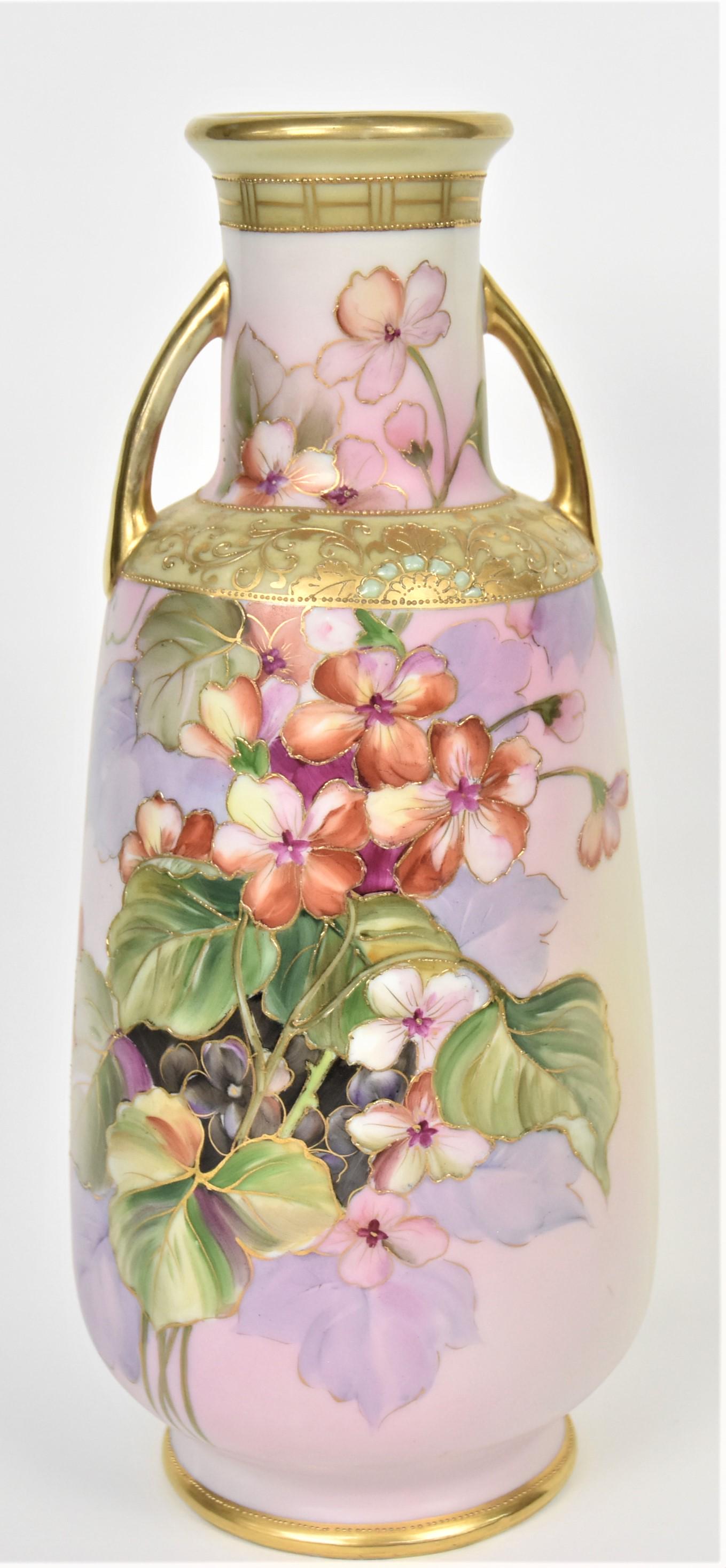 Nippon Jewel and Geranium Vase: Featuring ornate raised gold shoulder trim and gold handles. 11 1/2" tall, M in wreath logo. Highly attractive and in good condition.